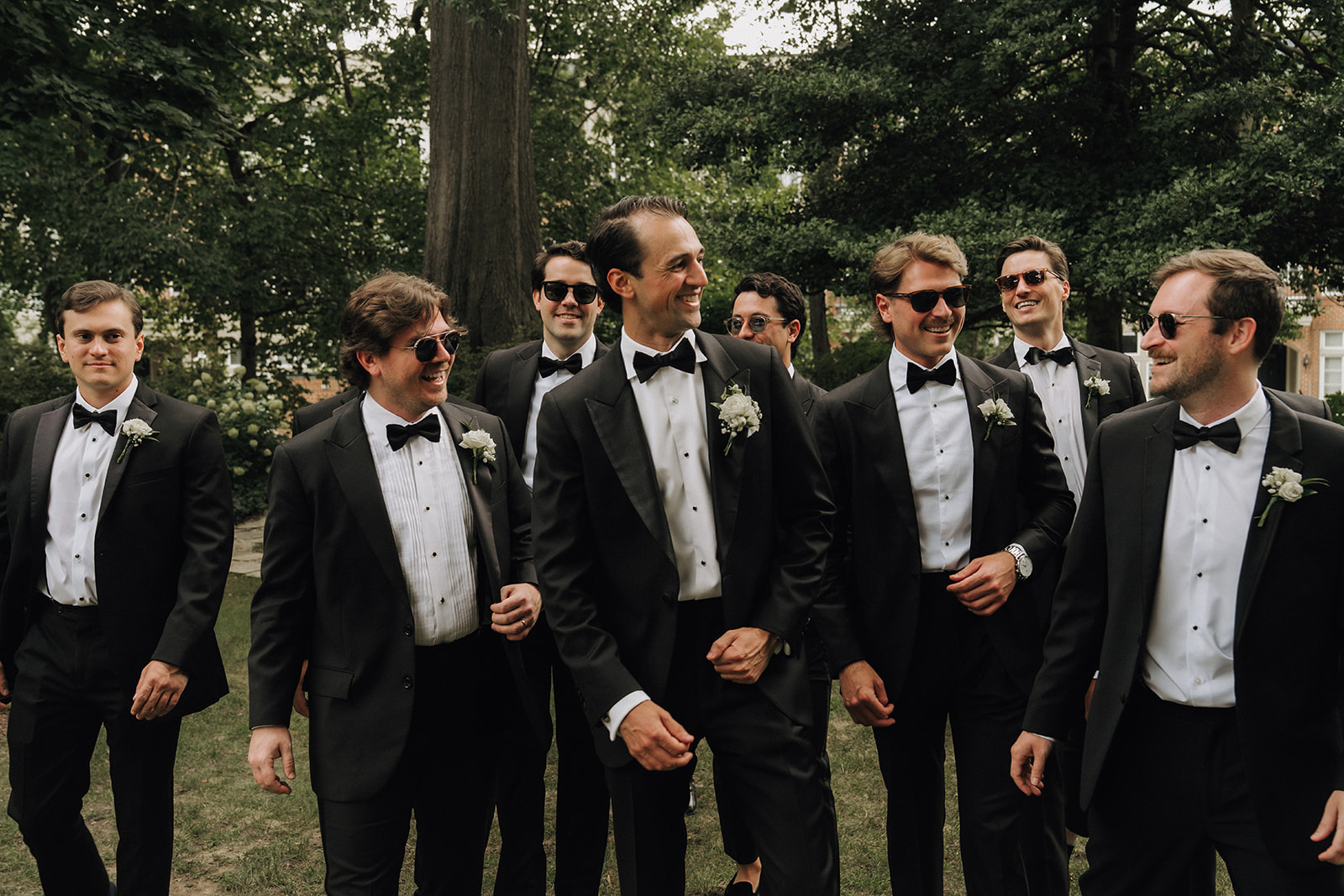 Groom and groomsman walking towards the camera looking at each other, Wedding photography at Meridian House venue in Washington DC.