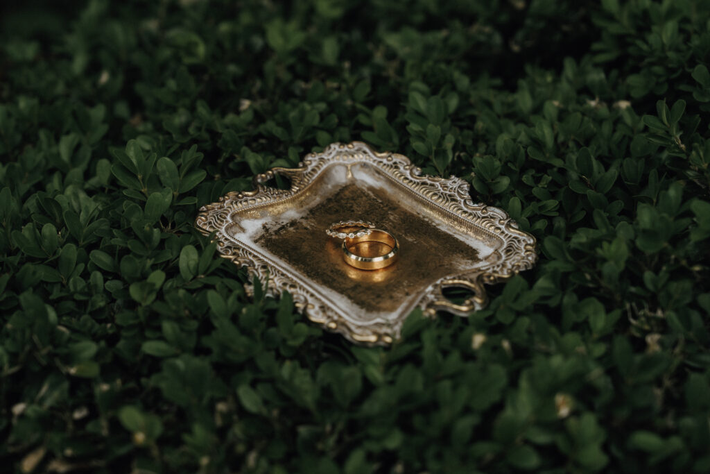 wedding rings on a gold plate