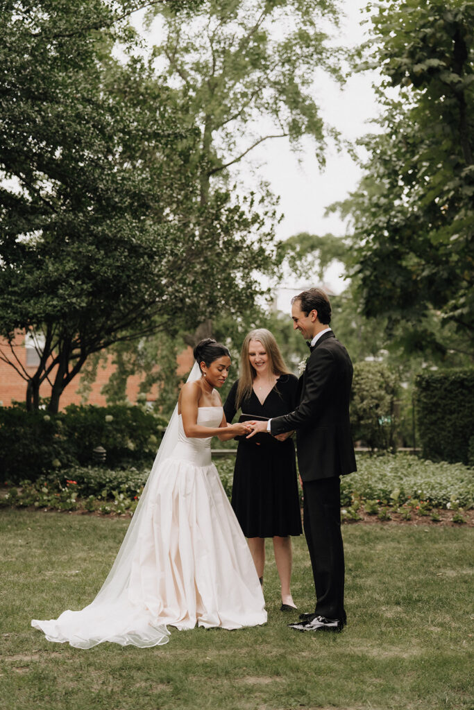 a photograph of a bride and groom holding hands at the altar during their wedding ceremony