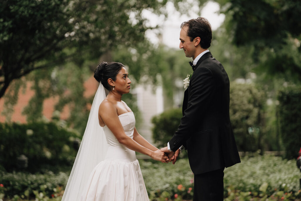 a photograph of a bride and groom holding hands at the altar during their wedding ceremony
