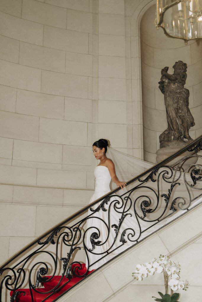 bride walking down staircase in meridian house wedding venue