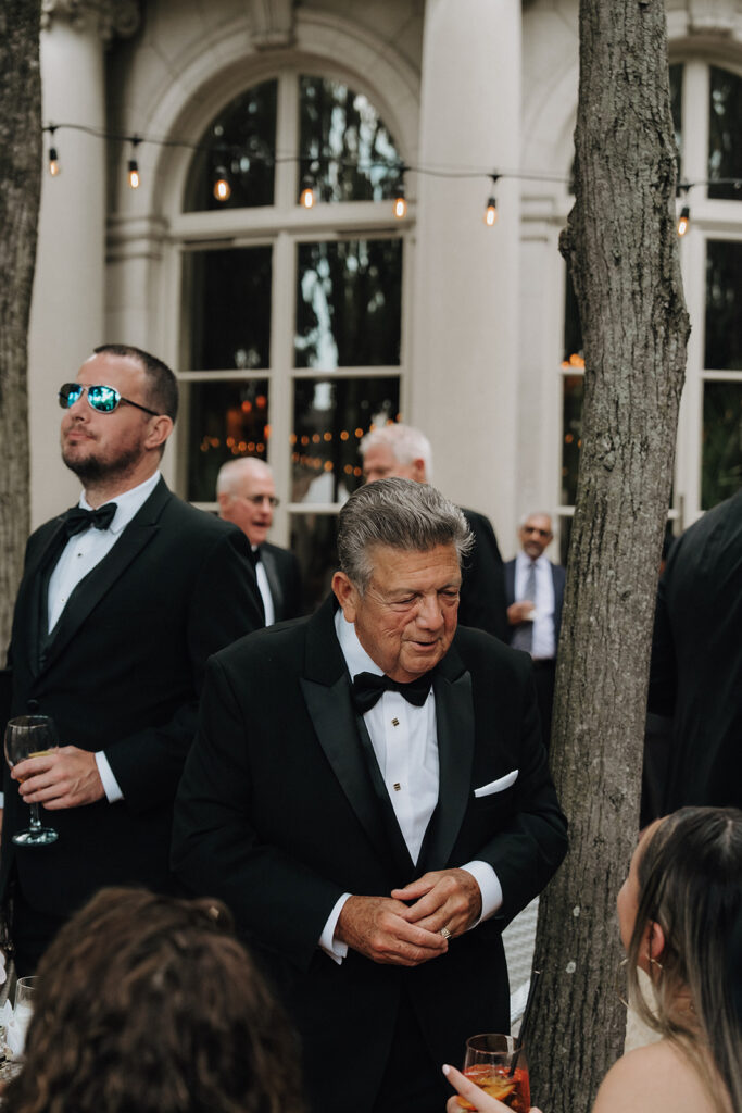 guests speaking to each other during cocktail hour at a wedding