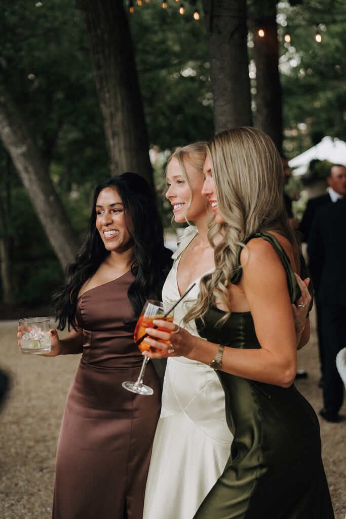 friends pose for a photo during cocktail hour of a wedding day