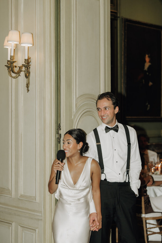 newlyweds giving a toast at their wedding at meridian house