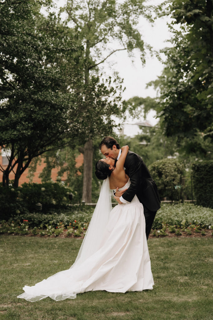 bride and groom's first kiss during their outdoor wedding ceremony